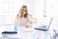 Businesswoman making a call while working on laptop in the office Royalty Free Stock Photo