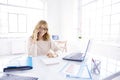 Businesswoman making a call while working on laptop in the office Royalty Free Stock Photo