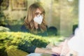 Middle aged woman wearing face mask for prevention while working from home Royalty Free Stock Photo