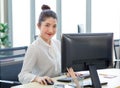 Portrait shot of Millennial Asian young professional successful female businesswoman secretary sitting smiling looking at camera Royalty Free Stock Photo