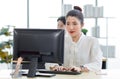 Portrait shot of Millennial Asian young professional successful female businesswoman secretary sitting smiling looking at camera Royalty Free Stock Photo