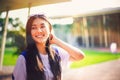 Portrait shot of young Asian female student smiling outdoor Royalty Free Stock Photo