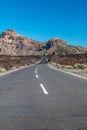 Road though field of solidified lava leading to mountains