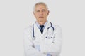 Portrait shot of serious faced male doctor standing with arms crossed at isolated background Royalty Free Stock Photo