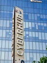 portrait shot showing the sign of cyberhub in cybercity shot against a blue glass skyscraper showing a social food