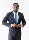 Portrait shot of smart and confident middle-aged African businessman in a neat formal black suit looking at the camera isolated Royalty Free Stock Photo