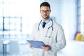 Male doctor standing in doctor`s office and working Royalty Free Stock Photo