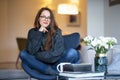 Relaxed young woman portrait daydreaming at home