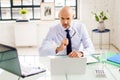 Portrait shot of stressed businessman working on laptop at the office Royalty Free Stock Photo
