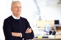 Elderly businessman portrait while standing with their arms crossed in the office Royalty Free Stock Photo