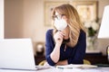 Middle aged woman wearing face mask for prevention while working from home Royalty Free Stock Photo