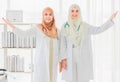 Portrait shot of two confident young adult Muslim doctors with a stethoscope around the neck standing and looking at the camera Royalty Free Stock Photo