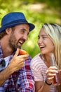 Portrait shot of young cheerful couple smiling at each other. Summertime camping in nature. Togetherness, fun, lesiure, holiday,