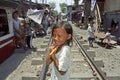 Portrait shy Filipino girl on railroad through slum