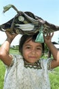 Portrait of shy Ixil Indian girl with school supplies