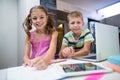 Portrait of siblings doing their homework in kitchen Royalty Free Stock Photo