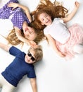 Portrait of siblings lying on a white background