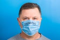 Portrait of a sick man wearing medical mask with text at blue background. concept. Protect your health Royalty Free Stock Photo