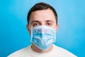 Portrait of a sick man wearing medical mask with MERS text at blue background. concept. Protect your health