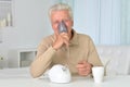 Portrait of sick old man with inhaler Royalty Free Stock Photo