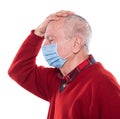 Portrait of sick old man in medical mask posing in studio