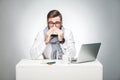 Portrait of sick scribble young boss in white shirt, scarf and black tie are sitting in office and need to finish important report