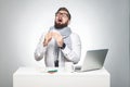 Portrait of sick scribble young boss in white shirt, scarf and black tie are sitting in office and need to finish important report