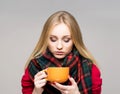 Portrait of a sick teenage girl with a cup of hot drink Royalty Free Stock Photo
