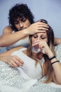 Portrait of sick woman drinking water on bed Royalty Free Stock Photo