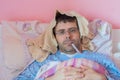 Man with flu into bed Royalty Free Stock Photo