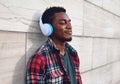 Portrait side view close up smiling african man in wireless headphones enjoying listening to music Royalty Free Stock Photo