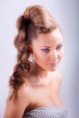 portrait sideview of blonde girl in elegant whimsical coiffure