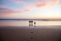 Portrait silhouettes of three children and mum happy kids with mother on beach at sunset. happy family, woman, two Royalty Free Stock Photo