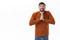 Portrait of silly and cute smiling handsome man, begging for help, need advice, asking for offer, holding hands in pray Royalty Free Stock Photo