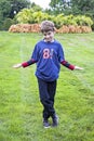 Portrait of silly eight year old birthday boy wearing number 8 shirt