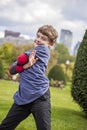 Portrait of silly eight year old posing in a city park Royalty Free Stock Photo