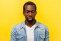 Portrait of silly funny positive man crossing eyes looking at his nose. indoor studio shot isolated on yellow background