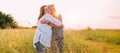 Portrait of sincerely smiling young pregnant woman dressed in light summer clothes with mother in evening sunset hours. They are Royalty Free Stock Photo