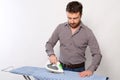 Portrait of single man ironing a shirt