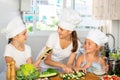 Young woman and two girls cooking together Royalty Free Stock Photo