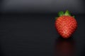 Portrait of a single and red strawberry Royalty Free Stock Photo