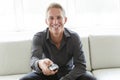 Portrait of single 40s man sitting in sofa tv remote Royalty Free Stock Photo