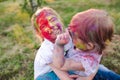 Portrait of the sisters, painted in the colors of Holi.