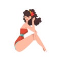 Portrait of sitting woman dressed in red retro swimsuit. Fashionable young girl with floral hoop in her long curly