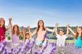 Happy kids holding hands up in lavender field Royalty Free Stock Photo