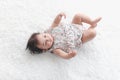 Portrait of six months crawling baby on fluffy white rug happy smiling adorable sweet little girl kid lying on bed in bedroom, Royalty Free Stock Photo