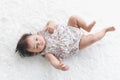 Portrait of six months crawling baby on fluffy white rug happy smiling adorable sweet little girl kid lying on bed in bedroom, Royalty Free Stock Photo