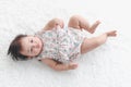 Portrait of six months crawling baby on fluffy white rug happy smiling adorable sweet little girl kid lying on bed in bedroom, Royalty Free Stock Photo