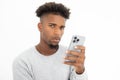 Portrait of skeptic African American man holding mobile phone Royalty Free Stock Photo