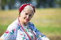 Portrait of a Slavic elderly woman in national ethnic dress. Ukrainian or Belarusian woman